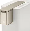A close-up, angled view of a white and gold coffee machine with a prominent gold dispensing unit. Produktbild-Vorschau