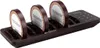A black charging base with multiple slots for pagers, with three pagers inserted. The pagers are round and have text and a decorative border. Produktbild-Vorschau