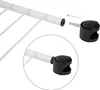 Close-up view of a white metal rod with white plastic ties, showing how to attach a black caster wheel with a metal stem. Náhľad obrázku produktu