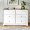 A white dresser with a wooden top is shown in a room with a painting and flowers. Anteprima dell’immagine prodotto