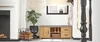 A hallway with a shoe cabinet, fireplace, and staircase. Produktbild-Vorschau