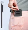 A hand is placing a black phone case into a back pocket of pink jeans. Produktbild-Vorschau