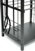 A close-up view of a black metal firewood rack with attached fireplace tools. Produktbild-Vorschau