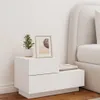 A white nightstand with a plant and a framed picture on top, next to a bed. Anteprima dell’immagine prodotto