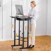 A woman is standing at a height-adjustable desk with a computer. Anteprima dell’immagine prodotto