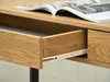 A close-up view of an open desk drawer and a magazine on the desk. Produktbild-Vorschau