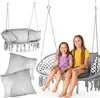 Two young girls sitting in a hanging chair swing, with another hanging chair and pillows in the background. Voir les images du produit