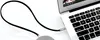 A black aux cable is connected to a silver laptop. Anteprima dell’immagine prodotto