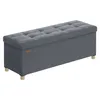 A gray upholstered storage bench with tufted detailing sits on a white background. Produktbild-Vorschau