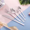 A set of silverware laid out on a pink and blue background with a decorative ribbon. Produktbild-Vorschau
