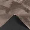 A close-up view of a rug, showing the texture of the pile and the anti-slip backing. Voir les images du produit