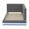 A gray upholstered bed frame with a slatted mattress support and blue LED lighting around the base, shown from a side angle. Produktbild-Vorschau