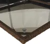 A close-up view of the corner of a wicker-style table with a glass top. Náhled obrázku produktu