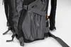 A close-up view of the side of a black and gray backpack, showing a mesh pocket. Náhľad obrázku produktu