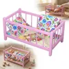 Ein hölzernes Puppenbett in Rosa mit Bettwäsche im Produktbild-Vorschau 1