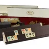 A close-up view of a Rummy/Okey game set, showing the tile racks and some of the game tiles. Náhľad obrázku produktu