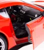 Close-up view of the interior of a red toy Ferrari car, showing the dashboard, steering wheel, and seats. Produktbild-Vorschau