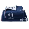 A stack of three navy blue towels with white anchor patterns, neatly folded. Produktbild-Vorschau