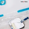 A painting roller and tray are placed on a floor covered with protective plastic sheeting, with blue painter's tape visible along a wall. Produktbild-Vorschau