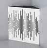 A white acoustic bass trap with a perforated pattern, placed in a corner of a room. Produktbild-Vorschau