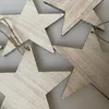 A close-up view of several wooden star-shaped ornaments, strung together with twine. Produktbild-Vorschau