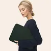 A woman holding a laptop sleeve. Náhľad obrázku produktu