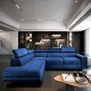 A blue sectional sofa in a modern living room with a stone accent wall and track lighting. Produktbild-Vorschau