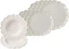 A stack of white plates with a decorative scalloped edge and embossed pattern. Produktbild-Vorschau