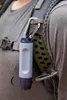 A person wearing a backpack with a water filter attached to the strap. Podgląd zdjęcia produktu