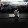 A person driving a car, with a car accessory on the dashboard. Produktbild-Vorschau