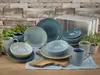 A collection of blue and gray ceramic dishes and mugs arranged on a wooden surface with a rustic wooden wall in the background. Náhľad obrázku produktu