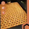 A bamboo bath mat with three circular icons on the left side. Anteprima dell’immagine prodotto