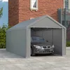 A gray car is parked inside a gray tent-like garage structure, with a brick building in the background. Náhled obrázku produktu