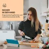 A young woman is preparing food in a kitchen, with a tablet in front of her. Produktbild-Vorschau