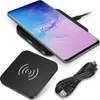 A black wireless charger with a phone on it and a charging cable next to it. Produktbild-Vorschau