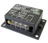 A black electronic device with labels and connectors, mounted on a flat surface. Produktbild-Vorschau
