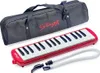 A red melodica with a black carrying case and accessories is displayed on a white background. Náhled obrázku produktu