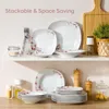 A display of dinnerware sets on shelves and a table, with decorative elements like a plant and cutting board. Produktbild-Vorschau