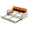 A light gray sofa bed with its pull-out bed extended, revealing wooden slats and built-in shelving with integrated lighting. Voir les images du produit