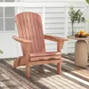 A wooden Adirondack chair sits on a wooden deck next to a small side table with a vase of greenery and some fruit. Produktbild-Vorschau