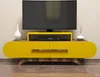 A modern yellow TV stand with a black television on top, placed in a room with a light-colored wall and wooden floor. Anteprima dell’immagine prodotto