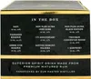 The image shows the side of a black and gold box with text detailing the contents of a tasting set. Produktbild-Vorschau