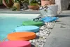 Poolside scene with colorful cushions and swimming accessories. Produktbild-Vorschau