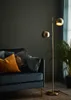 A modern living room scene with a sofa, floor lamp, and plant. Produktbild-Vorschau