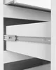 A close-up view of an open drawer in a white cabinet, showing the drawer slide mechanism. Produktbild-Vorschau