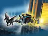 A LEGO Harry Potter set featuring a dragon-drawn carriage and figures, set against a backdrop of a stylized city and building. Náhled obrázku produktu