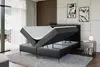 A modern bedroom with a black upholstered bed frame, showing the storage compartment open. Produktbild-Vorschau