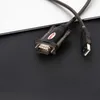 A USB to serial adapter cable is shown on a black textured surface with a white surface in the background. Anteprima dell’immagine prodotto