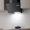 A modern black kitchen range hood mounted above a countertop. Voir les images du produit