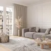 A modern living room with a gray sofa, a round wooden coffee table, and a large rug with a sunburst pattern. Voir les images du produit